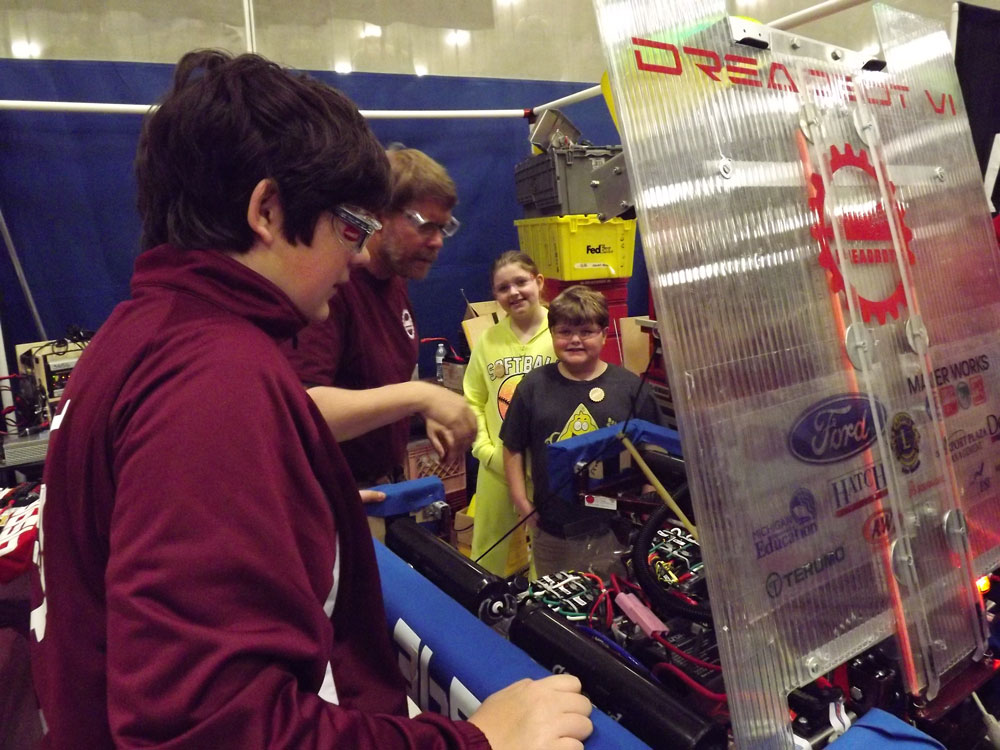 Two youngsters get a tour of our robot in the pit