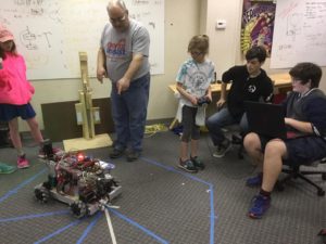 child drives robot while learning about it