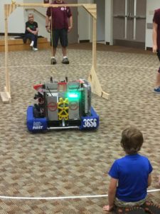 A child looks at our robot.