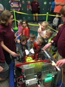 Kids looking at a robot