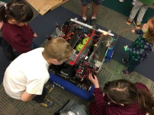 kids looking closely at our robot