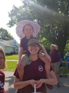 Sierra carries Lydia during the parade