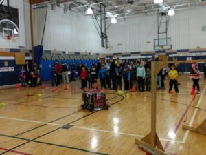 a crowd watches our robot pick up balls