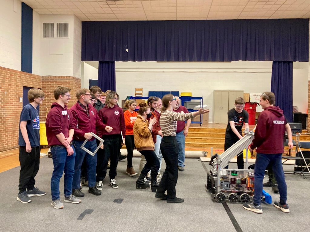 The mechanical/electrical team celebrates delivering the robot to the programming/vision team.